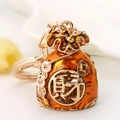 Amber-colored money bag keychain with golden 'Wealth' character and metal link - Yellow Fortune Bag