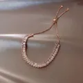 Close-up of rose gold adjustable bracelet with rectangular cubic zirconia on silk fabric - 22# Rose Gold Rectangular Zirconia Row Slider