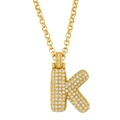 Detail of gold paved letter K pendant with sparkling crystals on a rolo chain - Letter K