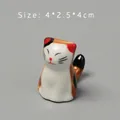 Macro shot of hand-painted ceramic cat chopstick rest with glossy finish and size info - 4*2.5*4cm / Style E