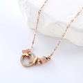 Elegant rose gold butterfly necklace with zircon pavé rings on natural white stone background - Rose Gold Necklace
