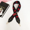 Detail of adjustable woven strap with red heart pattern and gold metal hooks - Heart Pattern Black Leather