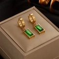 Golden hoop earrings featuring emerald green rectangular gemstone drops on a beige case - Earrings (Green Gemstone Dangles)