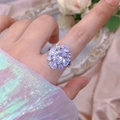 Macro shot of silver floral ring with sparkling cubic zirconia on pink silk background - 3D Floral Style (309) / Adjustable Open