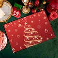 Detail view of red Christmas placemat featuring a golden line art tree and festive icons - CD30-8