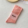 Pale pink cotton mid-calf socks with ribbed texture and decorative paper wrap - One Size / Carmine Pink