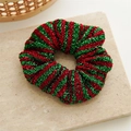 Macro view of metallic red and green striped scrunchie on marble background - Red Green Stripes