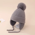 Détail du bonnet en maille grise avec protège-oreilles et grand pompon en fourrure - 5-12 Ans / Gris