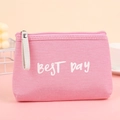 Pink canvas makeup bag with BEST DAY lettering and stylish white handle in lifestyle setting - Letter Pink