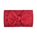 Soft nylon baby headband with a large red bow detail on a white background - Red (037)