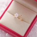 Macro shot of gold flower ring with white petals and zircons in a pink jewelry box - 7#14118 (Gold White Shell Flower Leaf)