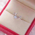 Macro shot of open ring with blue heart crystal, enamel flowers and cubic zirconia leaf - 19#14126 (Silver Light Blue Heart Flower)