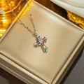 Elegant gold cross pendant necklace featuring colorful pink and blue gemstones on a display - 8855 Stainless Steel Color Diamond Cross