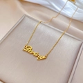 Dettaglio della collana con ciondolo Darling dorato su sfondo di seta bianca - Oro