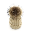 Detailed texture of beige knitted winter hat with large fluffy brown raccoon fur pompom - Lined Adult Style / Beige