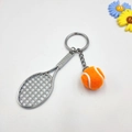 Tennis racket keychain set with metallic silver racket and orange felt ball pendant - Orange