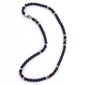 Detailed macro view of black matte beads and tiger eye stones necklace with silver spacers - Tiger Eye + Matte Stone Necklace