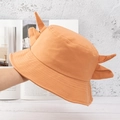 Close-up of orange bucket hat featuring cute small horns and soft cotton texture - Grapefruit Orange