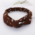 Brown twisted headband with small white flowers and blue leaves on a white background - Style 62 Brown Floral