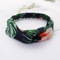 Navy blue fabric headband with green leaves and orange flower prints in a knotted style - Style 57 Navy Leaf/Orange Flower