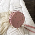 Pink round crossbody bag featuring floral embroidery and chain strap detail - Round / Pink