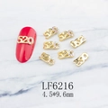 Macro detail of 520 gold alloy nail charms with colorful rhinestones on marble - Gold 520 Number With Colored Rhinestones (6216)