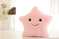 Detail of soft pink plush star pillow featuring an ON/OFF button for LED lighting function - 24cmx22cm / Pink