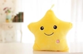 Macro detail of yellow plush star pillow featuring embroidered face and pink light button - 24cmx22cm / Yellow
