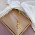 Macro shot of gold-plated bear pendant with crystal micro-paving in a beige jewelry box - Gold Teddy Bear Style (D205)