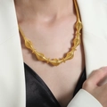 Modern gold plated spring coil necklace with artistic geometric spindle design on a model - Multi-segment Coil Design / Gold (P1775)