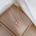 Close-up of pink heart gemstone necklace with gold floral accents on white satin - Pink Heart Gemstone Butterfly Flower Style / Gold-Pink