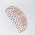 Detail of pink tortoiseshell acetate wide-tooth comb with semi-circular marble pattern - Pink