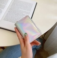 Hand holding a compact laser holographic card holder with rainbow finish and metal zipper - Laser Silver White
