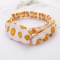 Soft white twisted headband featuring a cheerful yellow smiley face pattern design - Smiley Face White