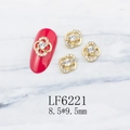 Macro shot of 8.5x9.5mm gold hollow clover nail charms with pearls and crystals - Gold Flower With White Stone Center (6221)