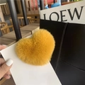 Yellow heart-shaped faux rabbit fur plush hair clip on a white display card - Mango Yellow