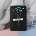 Detail of handmade black greeting card with blue dried baby's breath flowers - Blue Gypsophila - Black Card
