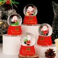 Set di quattro sfere di cristallo di Babbo Natale con basi rosse e fiocchi festivi - Diametro Sfera 6,5 cm / Buon Natale