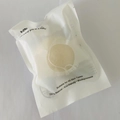 Light yellow round Konjac sponge in semi-transparent frosted bag with hanging hole - Bag Packaging / Natural White