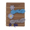 Detail view of 5-piece floral and bow nylon headbands set for baby girls on a display card - Blue Purple Pink Style