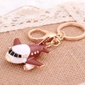Brown and white airplane keychain with crystal rhinestones on beige burlap background - Small Airplane Wine Red