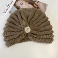 Detail of knitted turban hat with vintage rhinestone and pearl brooch decoration - Dark Khaki