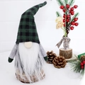 Plaid Christmas Gnome doll on wooden base with festive pine cone and berry decor - Black and Green Plaid