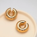 Close-up of golden hammered texture hollow ear cuffs on a ceramic tray display - Gold Hammered Hollow Ear Clip (MS-198)