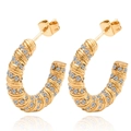 Close-up of gold-plated U-shaped earrings featuring spiral texture and pavé set zircons - 18K Gold / Gold with White Zirconia