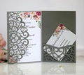 Detail of grey laser cut wedding invitation set with floral patterns and RSVP card - Silver Grey