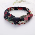 Cross knotted dark blue fabric headband with red and green floral print on white surface - Style 50 Navy Red/Green Flower