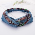 Blue elastic fabric headband featuring colorful ethnic embroidery and a twisted knot design - Style 88 Blue Ethnic Print