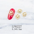 Detail of hollow gold flower nail charms with white pearls on red nail model - Gold Flower Retro Pearl Style (6227)