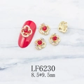 Detailed view of hollow flower nail charms with red rhinestones and gold base accents - Gold Flower Red Stone Aurora Rhinestone Style (6230)